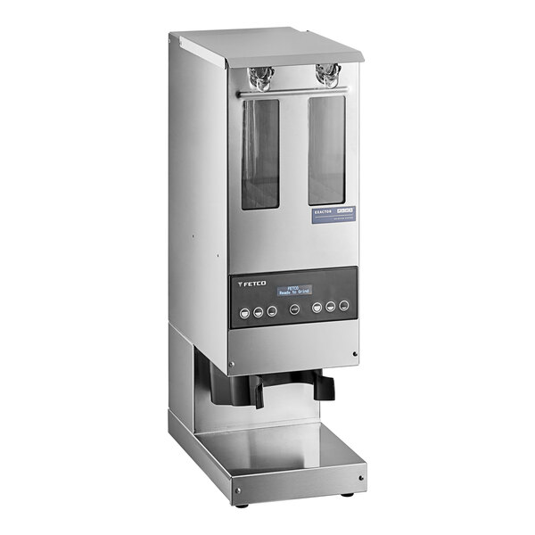 A silver stainless steel Fetco Double Hopper Coffee Grinder on a counter.