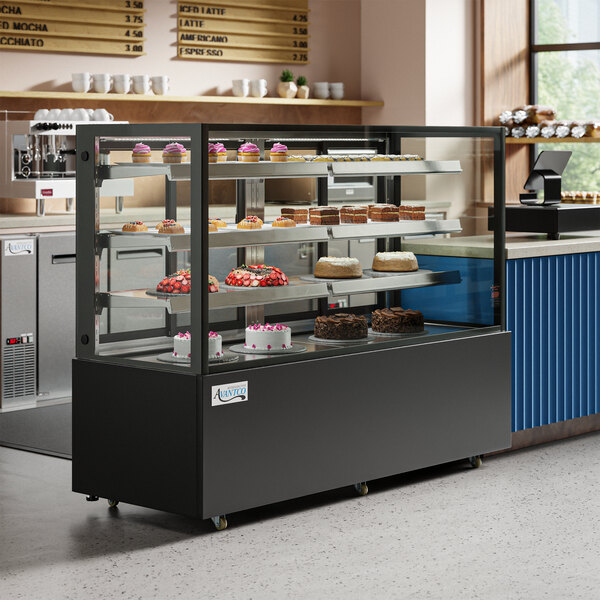 A refrigerated Avantco bakery display case with cakes on a counter.