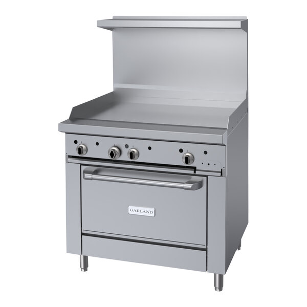 A stainless steel Garland range with a griddle, burners, and a convection oven.
