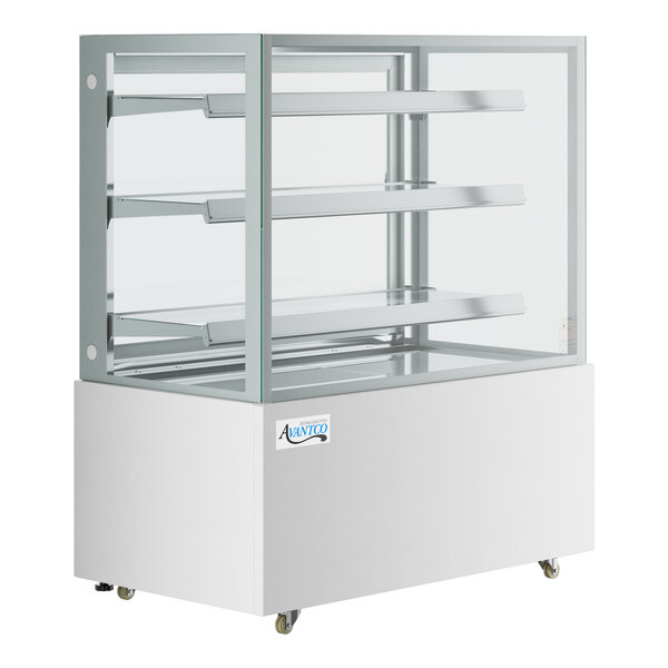 An Avantco white refrigerated bakery display case with glass shelves.