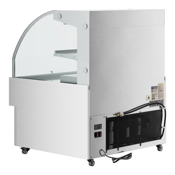 An Avantco white horizontal air curtain merchandiser with a glass door.