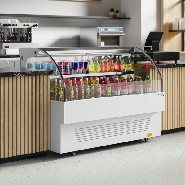 An Avantco white horizontal air curtain merchandiser with drinks on display.
