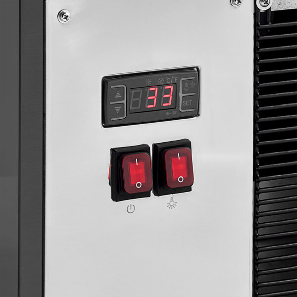 A close up of a control panel with a digital display on a black machine.