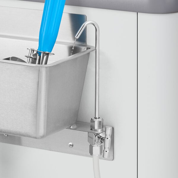 A metal container with a Regency dipper well faucet with a blue handle.