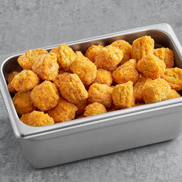 A metal container full of Revel Eats Guacamole Bites.