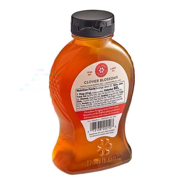 A bottle of Dutch Gold Raw Clover Honey with a label.