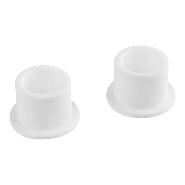 Two white plastic bushings with a hole on a white background.