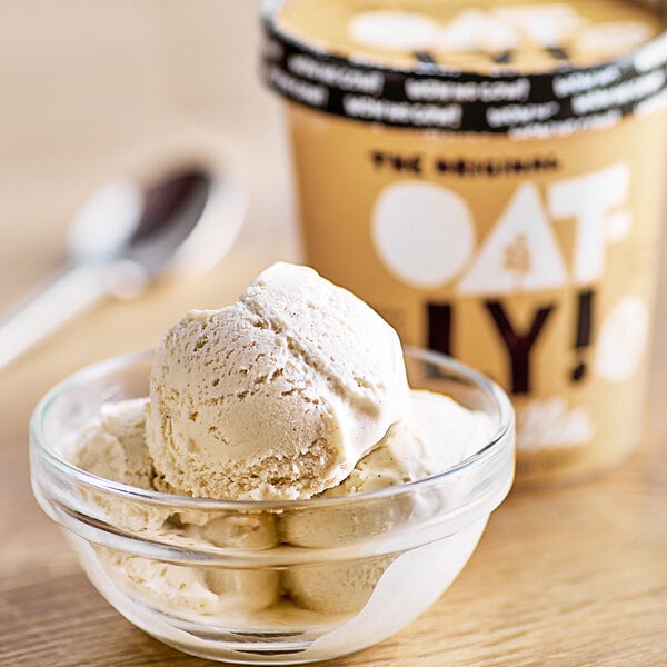 A bowl of Oatly vanilla oat milk ice cream with a spoon.