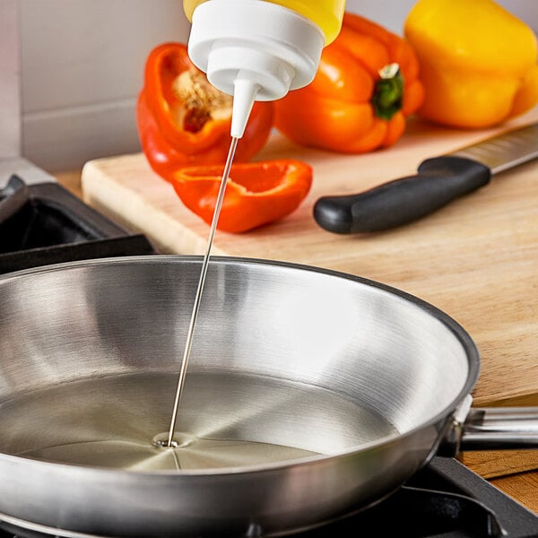 A person pouring Zero Acre all-purpose cooking oil into a frying pan.