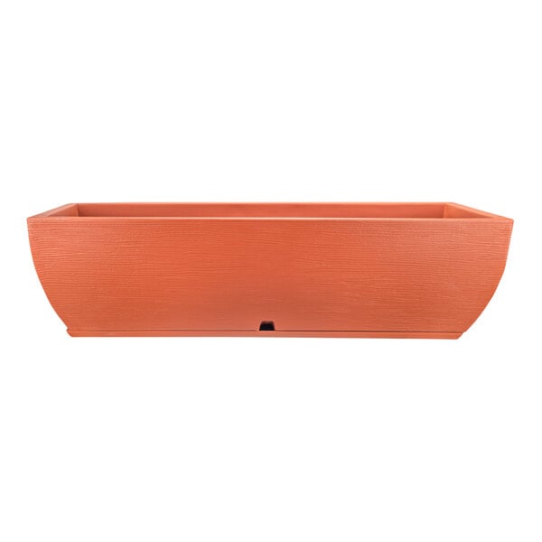 A rectangular terra cotta planter box with a red base.