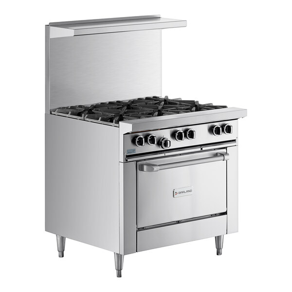 A large stainless steel Garland range with 6 burners and a convection oven.