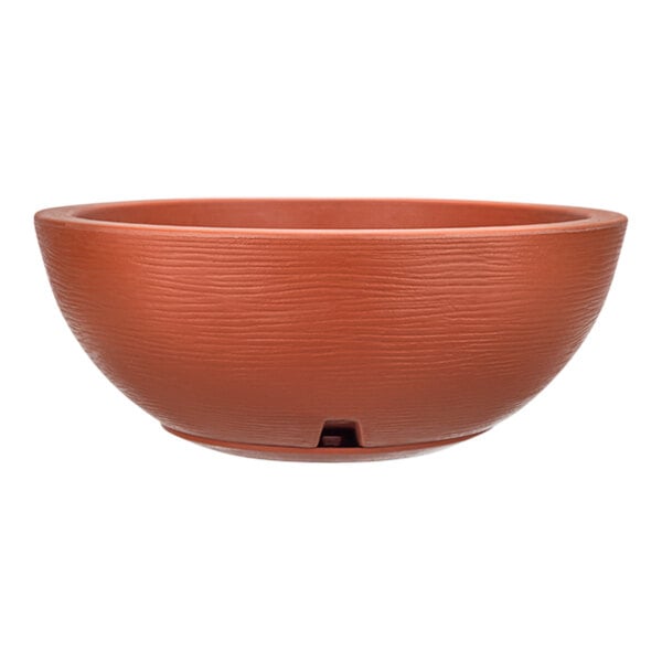 A brown round bowl with a handle on it.