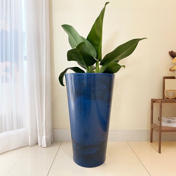 A Floridis blue marble planter with a plant in it.