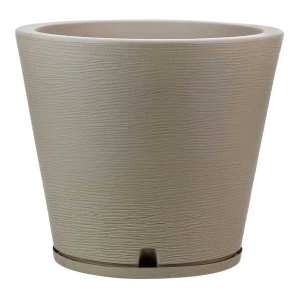 A Floridis round beige planter with a white rim.