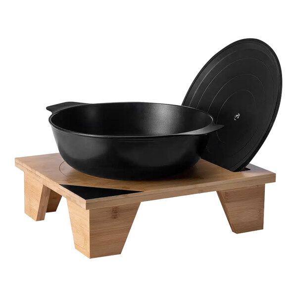 A black wok and lid on a Rosseto bamboo pot stand with chalkboard corner.