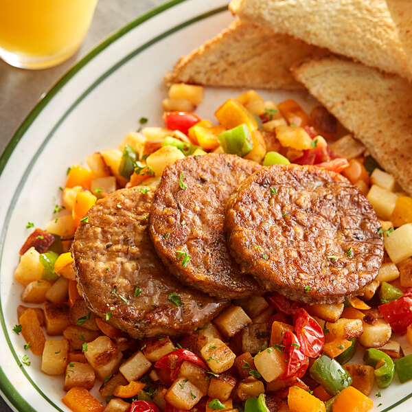 A plate of food with toast, potatoes, and Gardein plant-based vegan sausage patties.