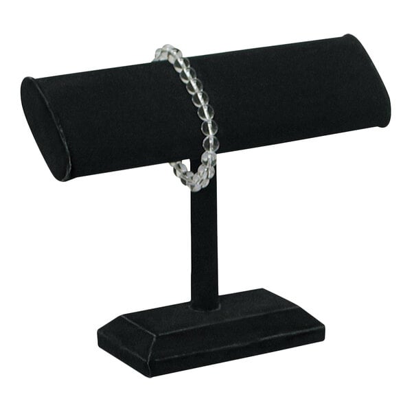 A black velvet T-shape bracelet display stand with a bracelet on it.