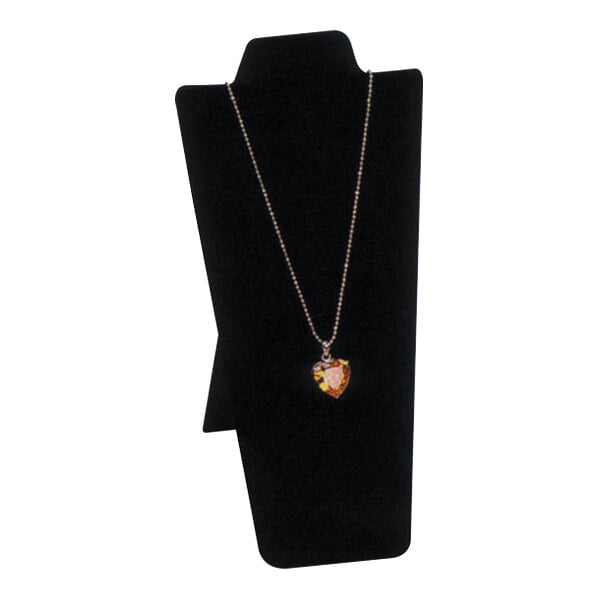 A heart shaped pendant on a chain displayed on a black velvet necklace stand.
