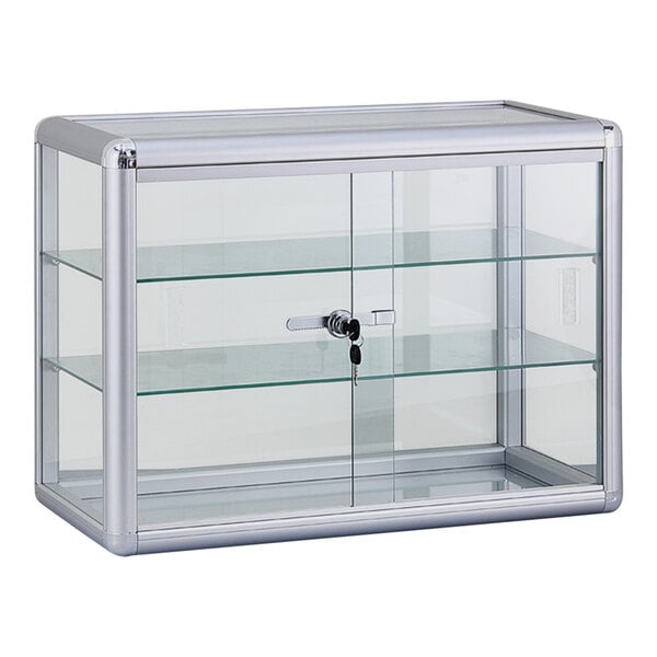 A 24" x 12" x 18" Glass 2-Shelf Locking Countertop Display Case with Aluminum Frame on a counter in a bakery display with a key lock.