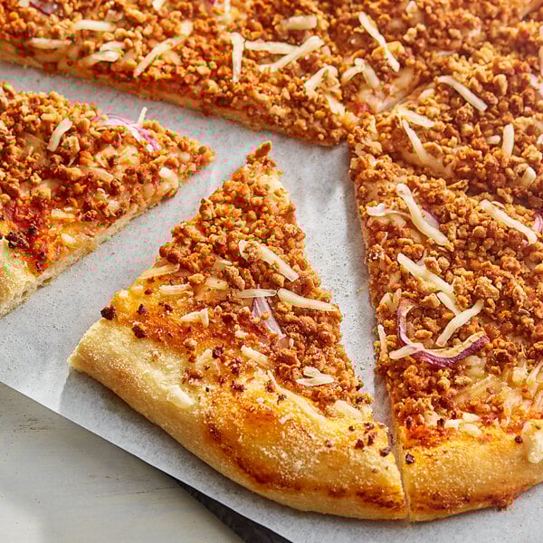 A slice of pizza with Gardein Italian Pizza Crumbles and cheese on top.