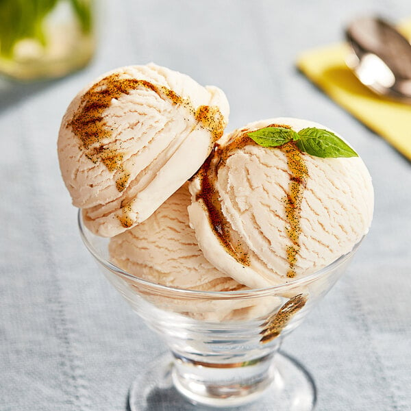 A bowl of Lloyd's of Pennsylvania vanilla custard ice cream with brown specks.