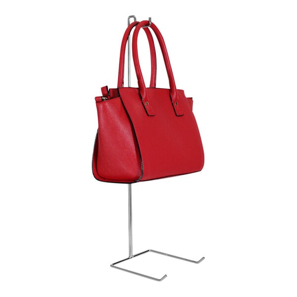 A red purse on a chrome-plated steel adjustable-height countertop display rack.