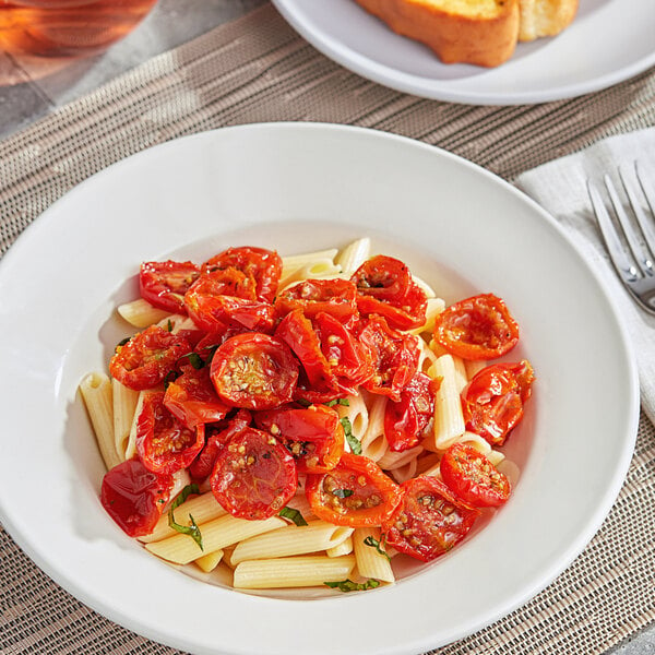 A plate of pasta with Sevillo Fine Foods slow roasted cherry tomato halves and herbs.