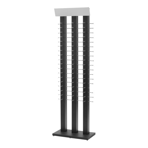 A black metal wall eyewear display stand with shelves and a mirror.