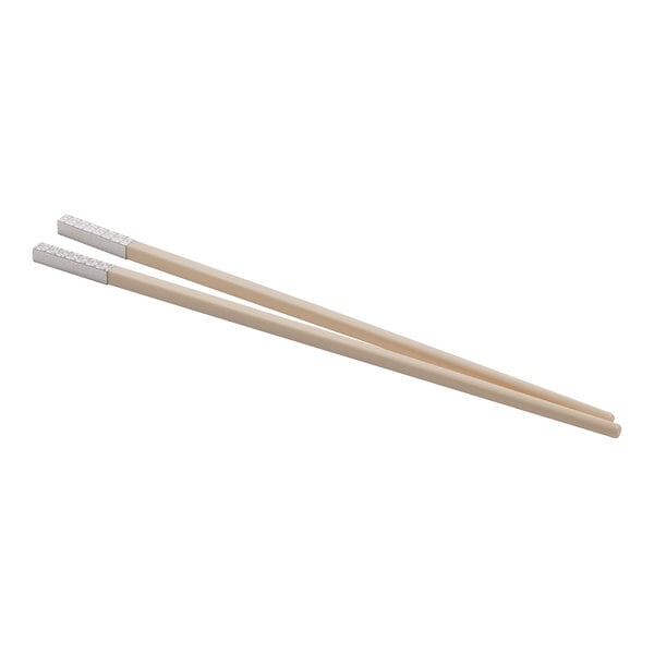 A pair of WNK ivory melamine chopsticks with wooden handles.