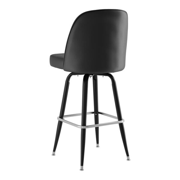 A Lancaster Table & Seating black barstool with metal legs and a black vinyl bucket seat.