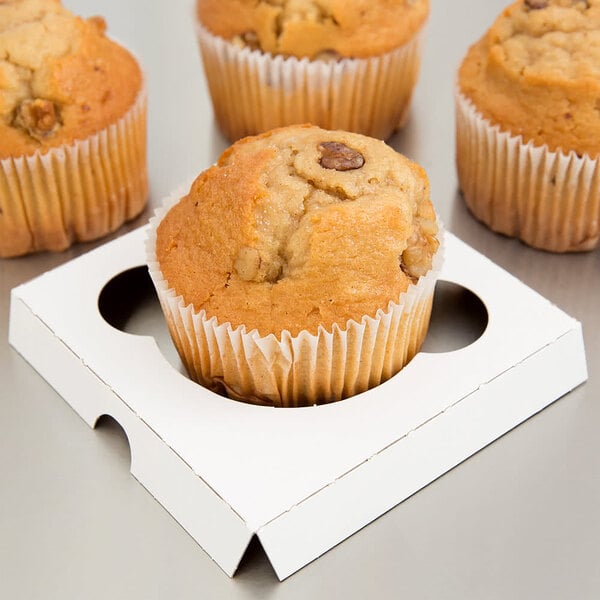 A group of three muffins in a white Baker's Lane cupcake insert.