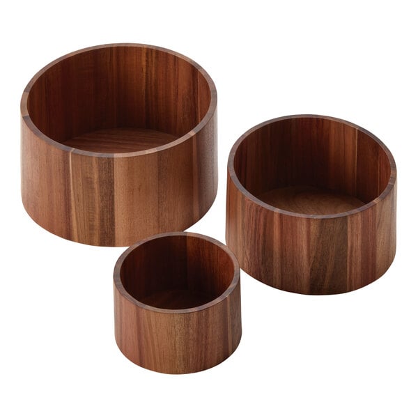 A group of American Metalcraft acacia wood risers on a table.