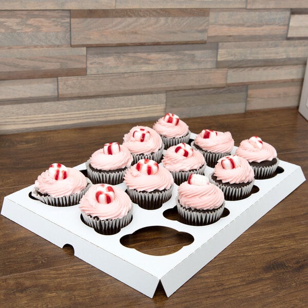 A white Baker's Lane cupcake insert holding 12 cupcakes on a table.