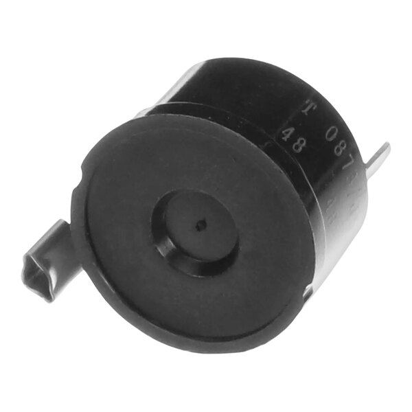 A black circular Ice-O-Matic overload compressor with a metal clip.