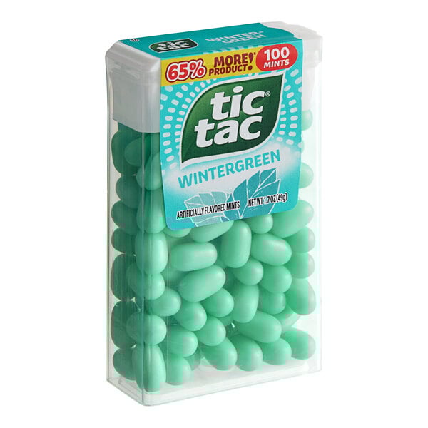 A green plastic container of Tic Tac Wintergreen mints.