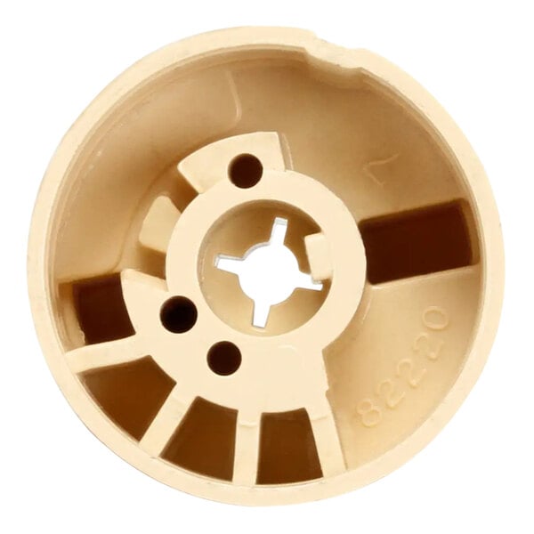 A close-up of a beige circular Pitco unitrol dial with holes in it.