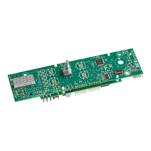 A green electronic circuit board with metal knobs and switches.