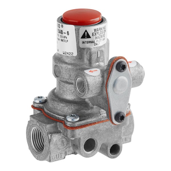 A close-up of a Vulcan Baso pilot safety valve with a red button.