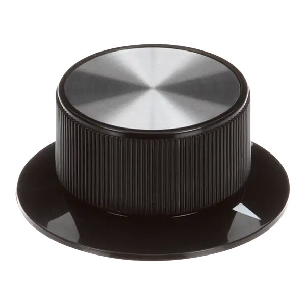 A close up of a black and silver Vulcan knob with a circular design.