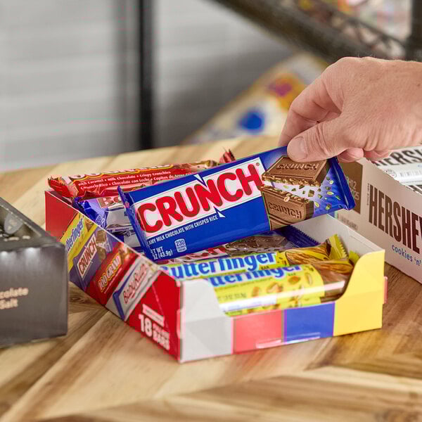 A variety pack of full size Ferrero chocolate bars including Crunch and Butterfinger displayed in an open box.