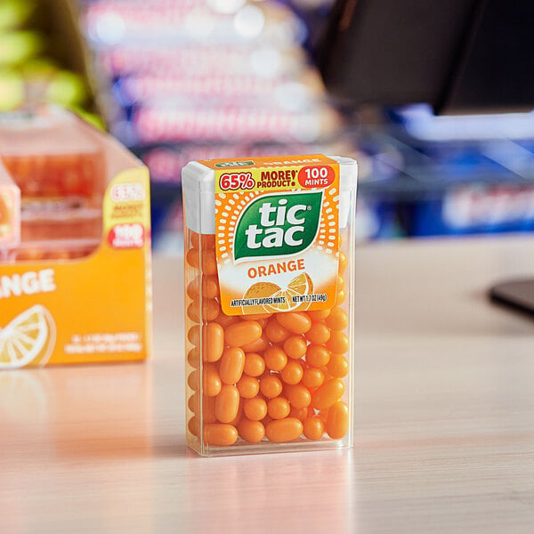 A box of TIC TAC Orange Mints on a table.