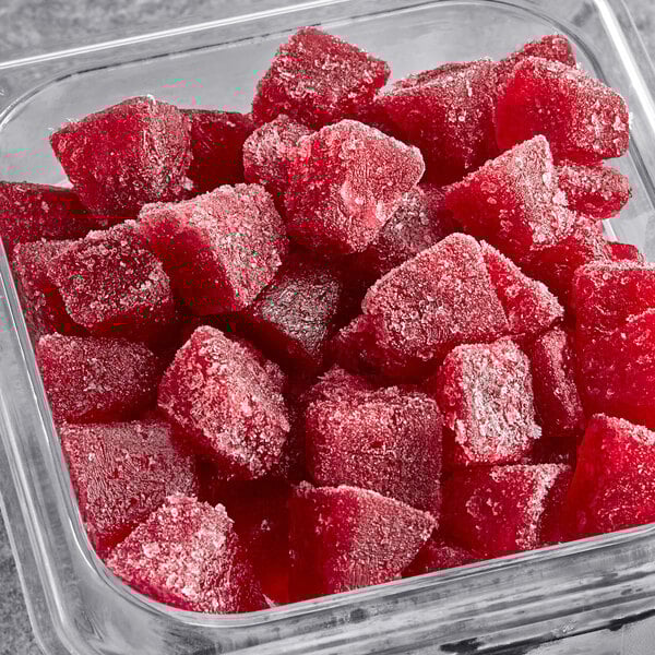 A square container filled with red Pitaya Foods organic pomegranate cubes.