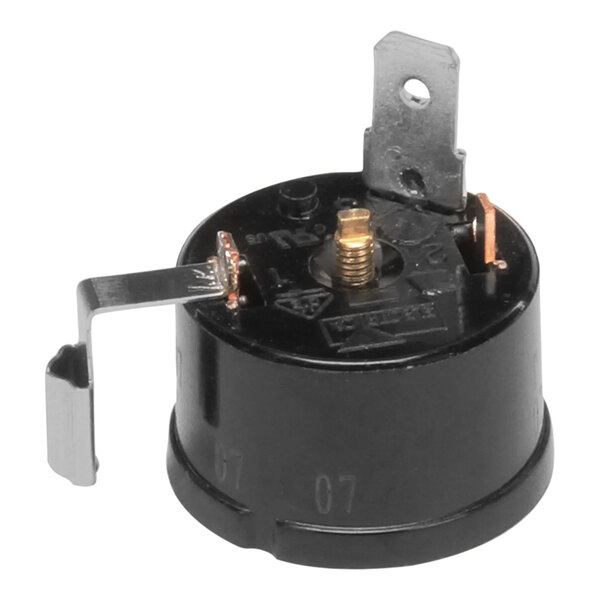 A black round device with a metal plate and screws.