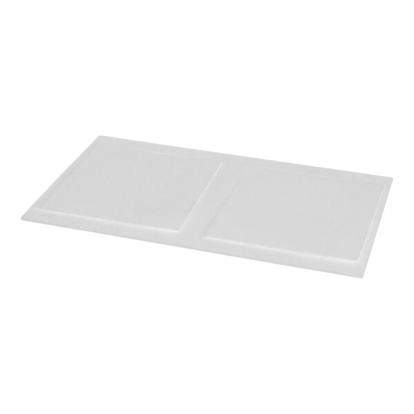 A white rectangular gasket with two square objects.