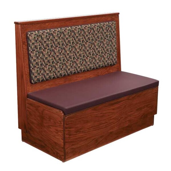 An American Tables & Seating wood booth with a purple cushion on the seat and back.