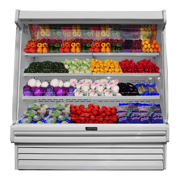 A white Howard McCray vertical open air curtain produce merchandiser with shelves of fruits and vegetables.