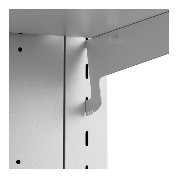 A white metal shelf with holes.