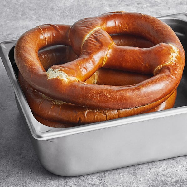 Two Ditsch soft pretzels in a metal pan.