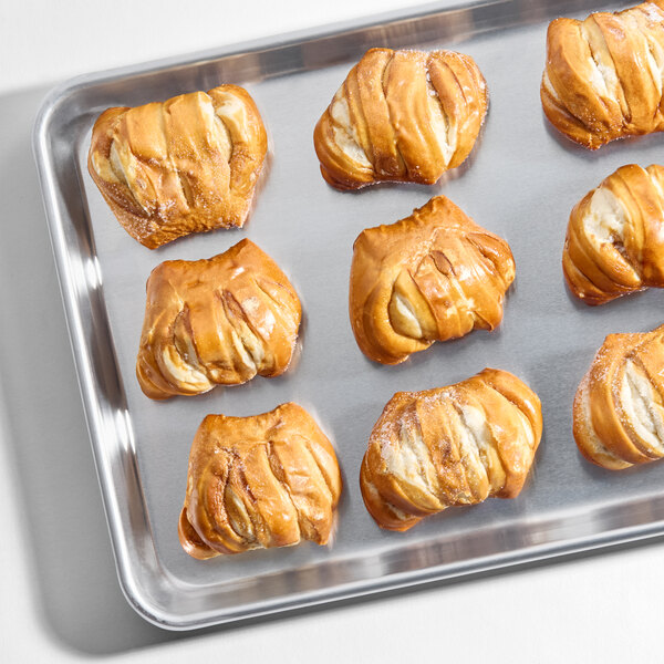 A tray of sliced soft pretzel slider buns.