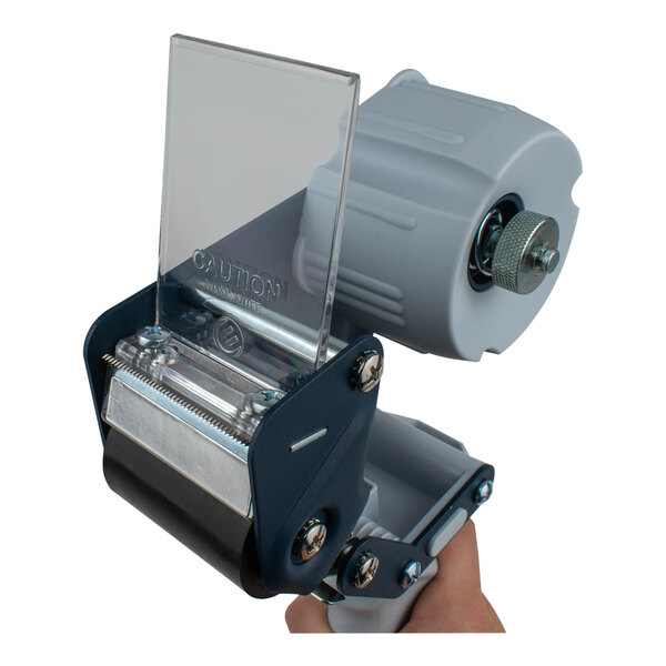 A hand using an Encore Packaging heavy-duty pistol-grip tape dispenser to hold a clear plastic object.